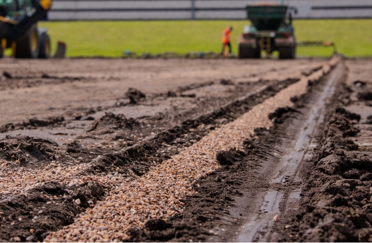 channels being dug for sports field irrigation system