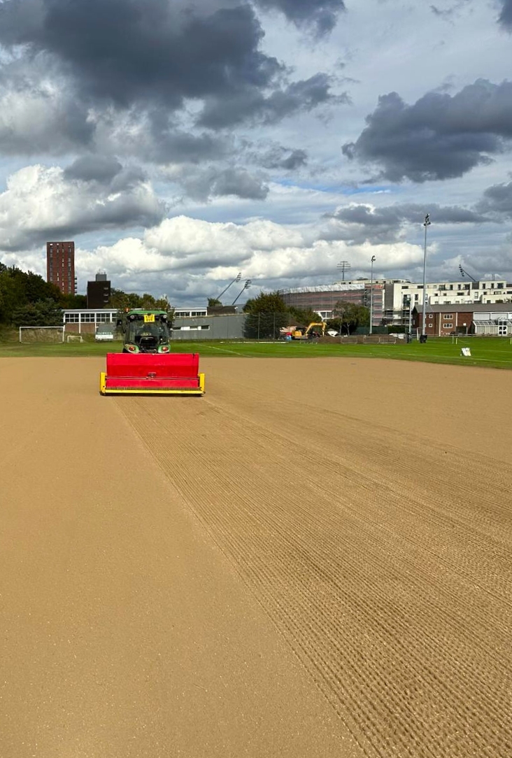 tennis court builder flattening ground out