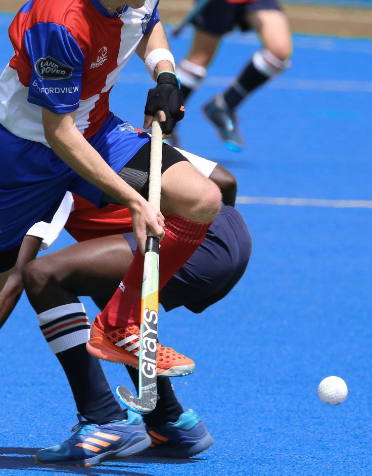 hockey players battling over ball