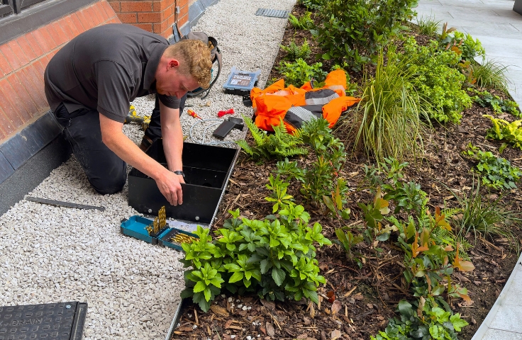person attending to the maintenance chamber of a blue green roof