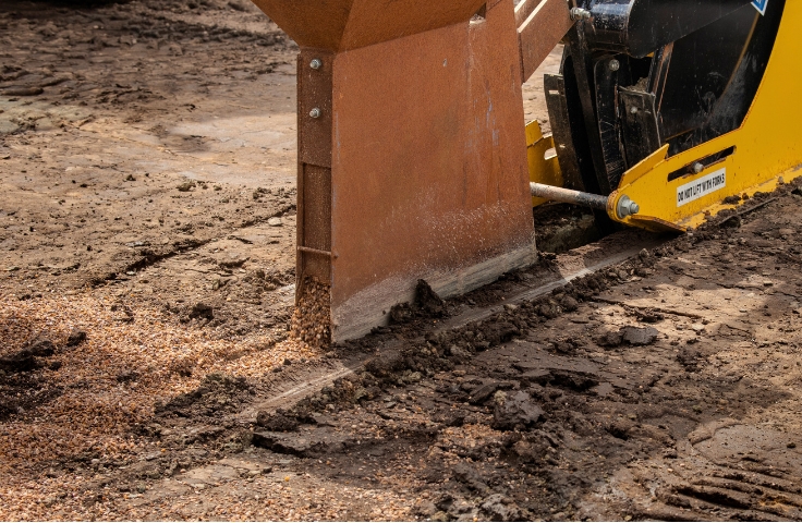 drainage channel being cut out by machinery