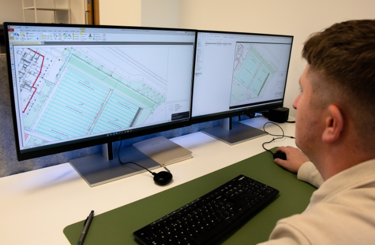 person looking at design plans for project