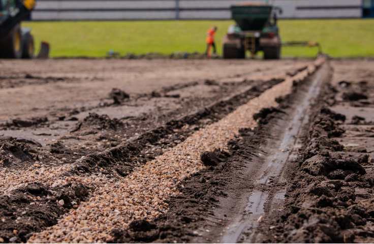 drainage channels being dug and filled in