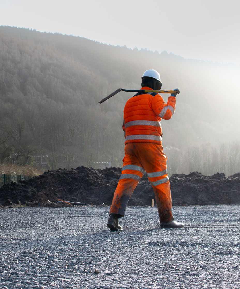 builder with shovel over his shoulder