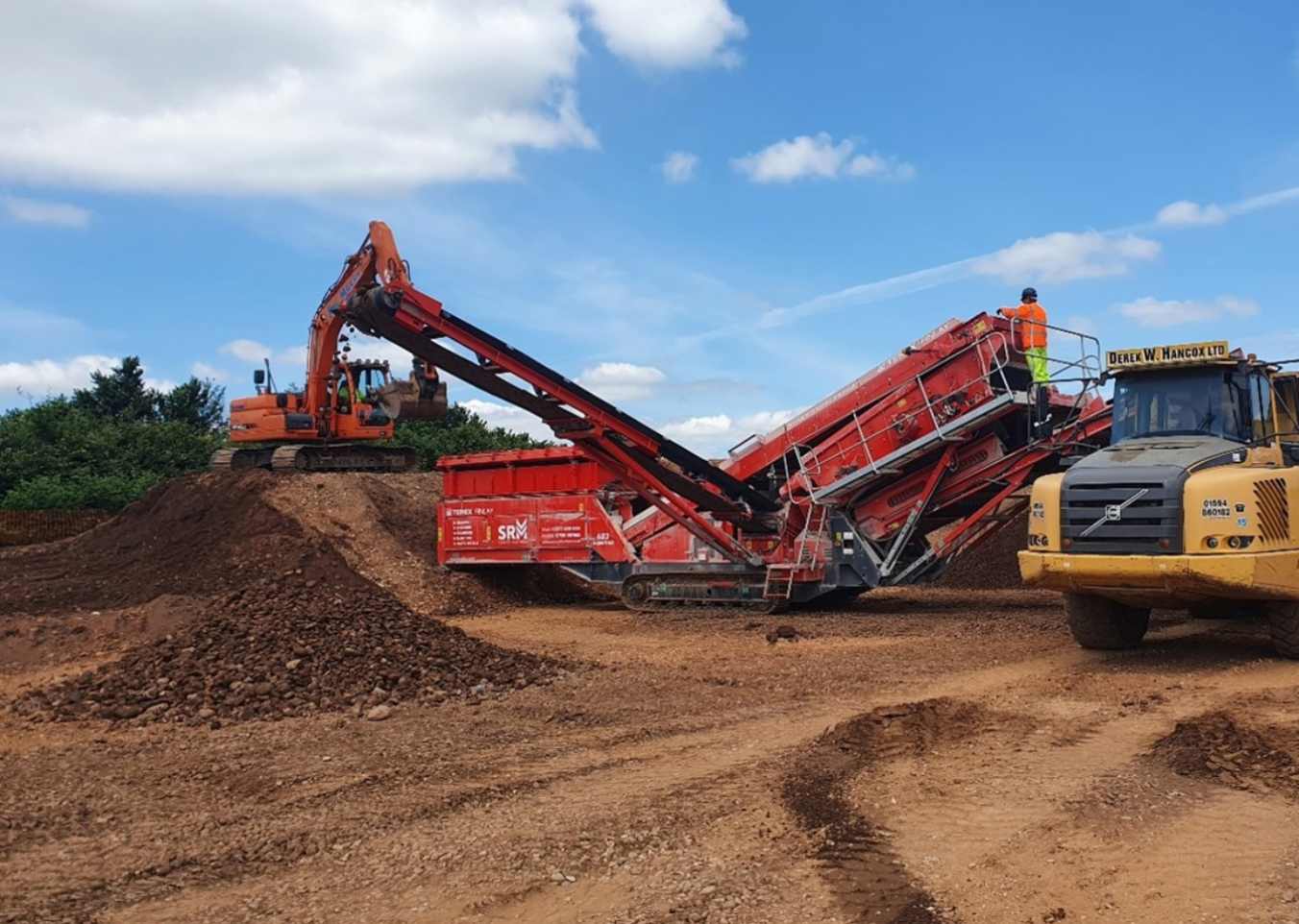 machinery moving dirt mounds