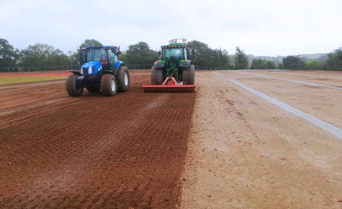two tractors levelling ground