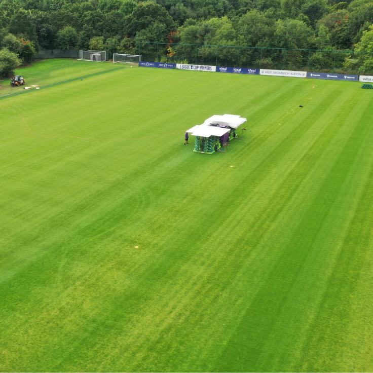 drone shot of hybrid pitch carpet being installed